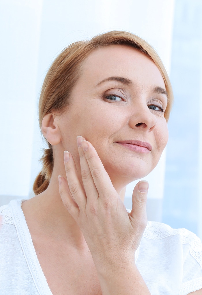 Middle-age woman touching her cheek